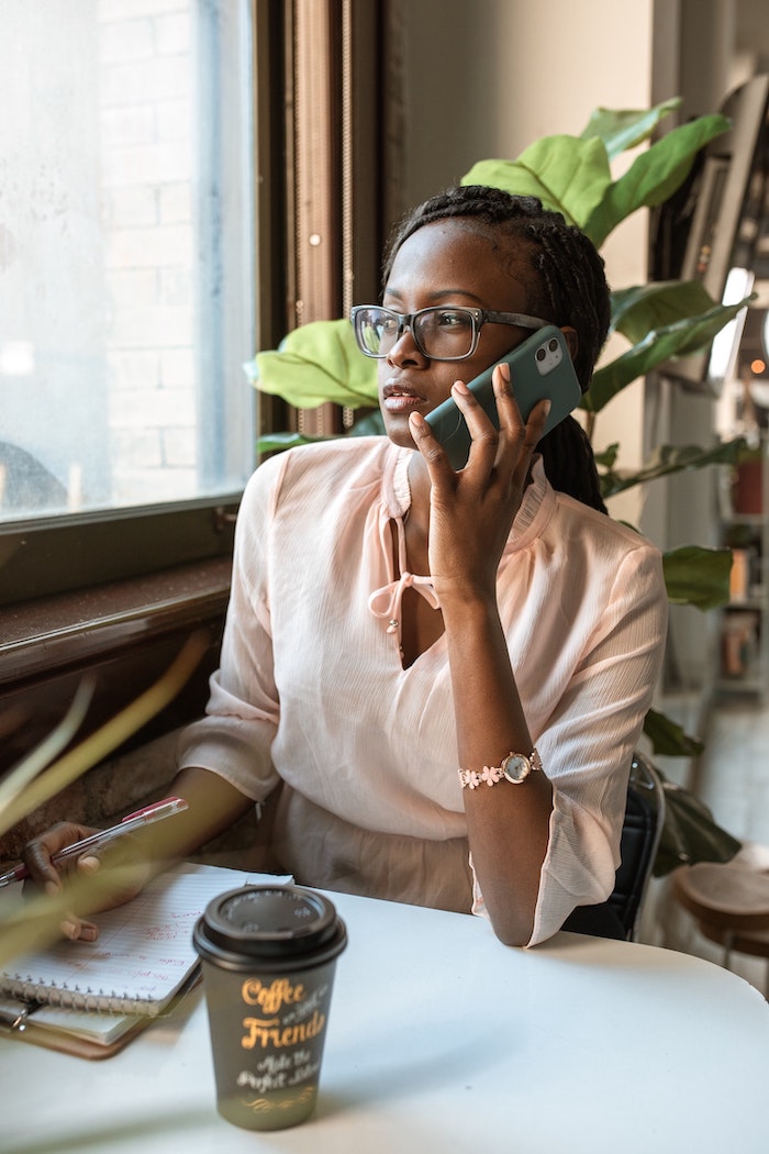 Black woman holding a phone